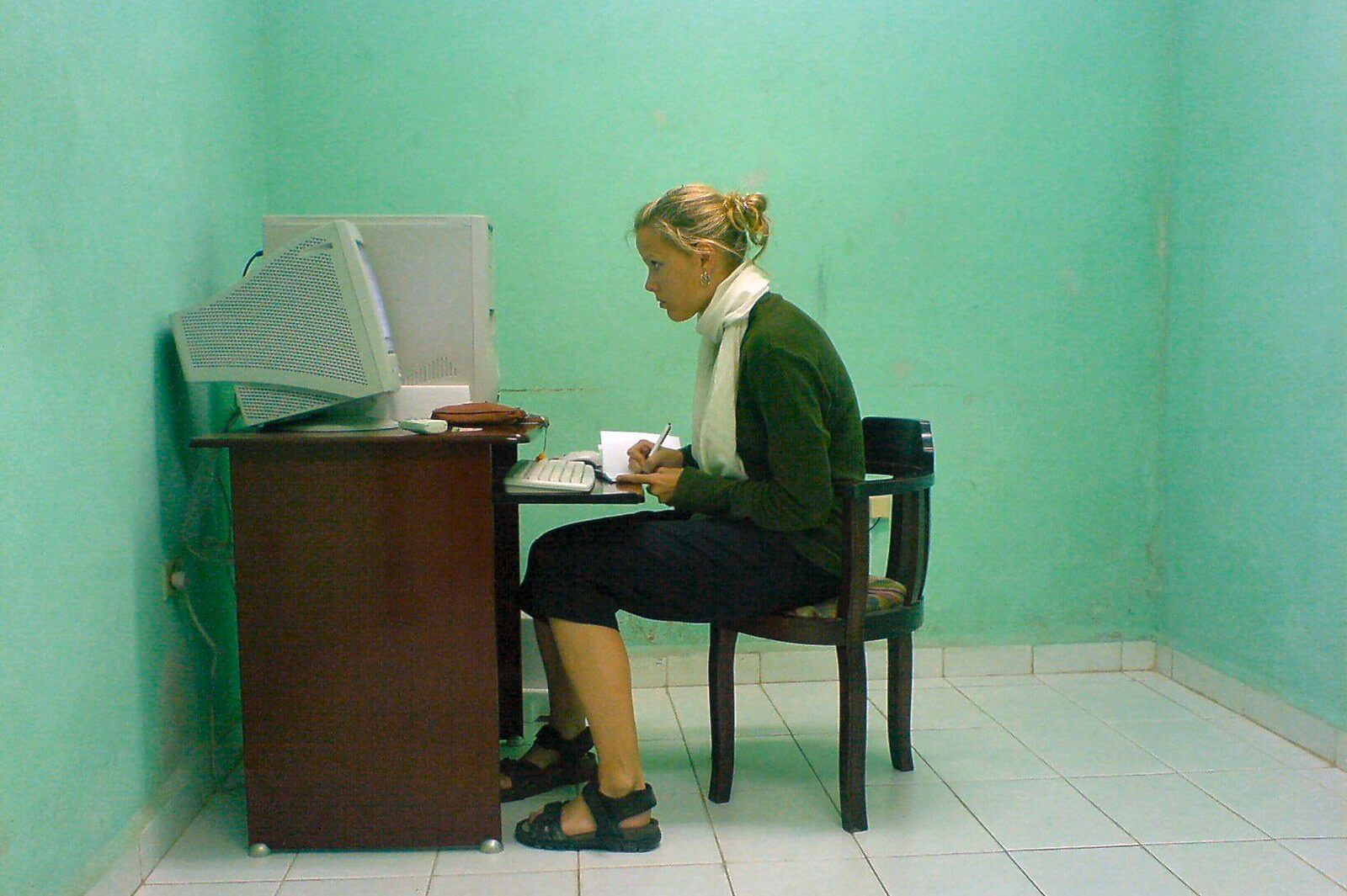 person sitting at desk in cyber cafe