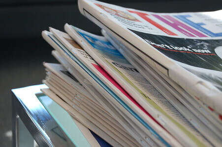 stack of old fashioned paper newspapers