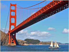 golden gate bridge spanning the bay with sailboats on beautiful sunny day in san francisco california